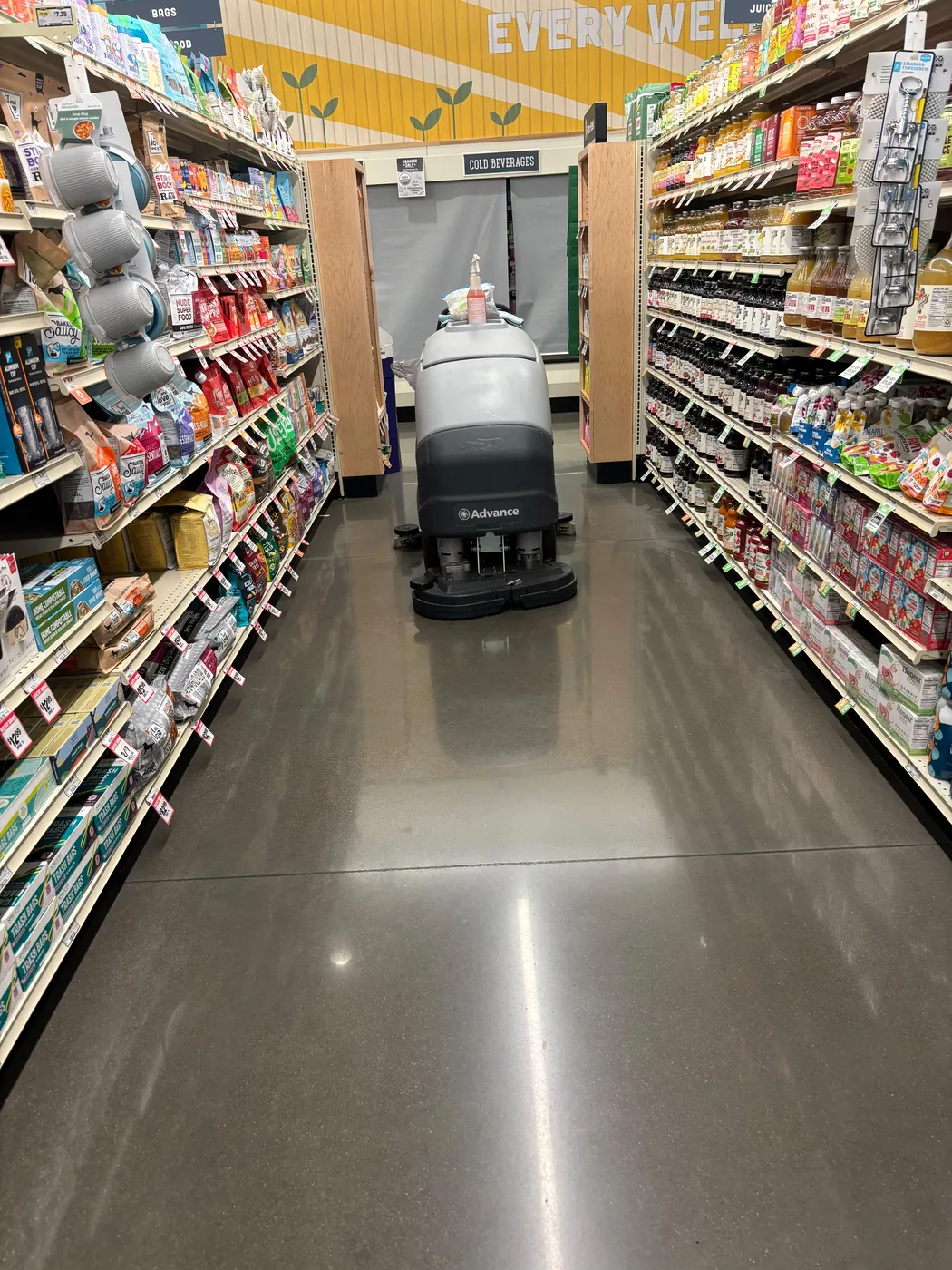 Ride-on scrubber maintaining a grocery store floor